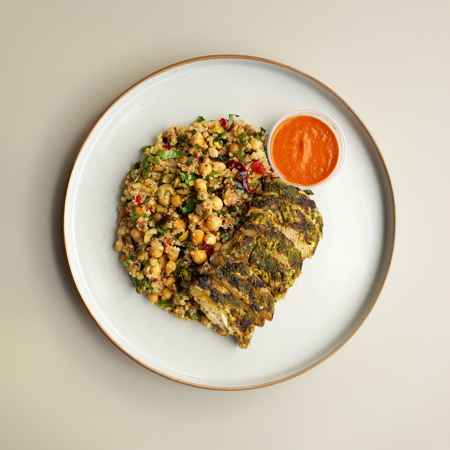 Mediterranean Grilled Chicken, Quinoa, Chickpea, Roasted Aubergine, Red Pepper, Sundried Tomato, and Olive Salad. Orange And Harissa Dressing