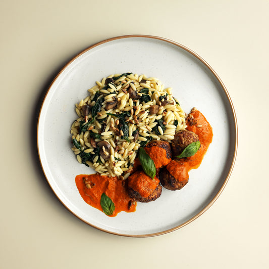 Beef Meatballs, Red Pepper And Basil Sauce, Sauteed Garlic Mushroom and Wilted Spinach Orzo, Toasted Sunflower Seeds